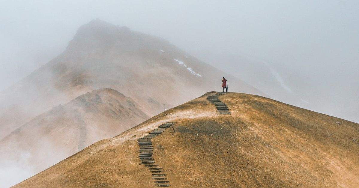 "Inspirational quotes on path through scenic nature background."